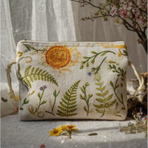 pochette "Equinoxe" Pochette avec des éléments botaniques et un soleil brodés